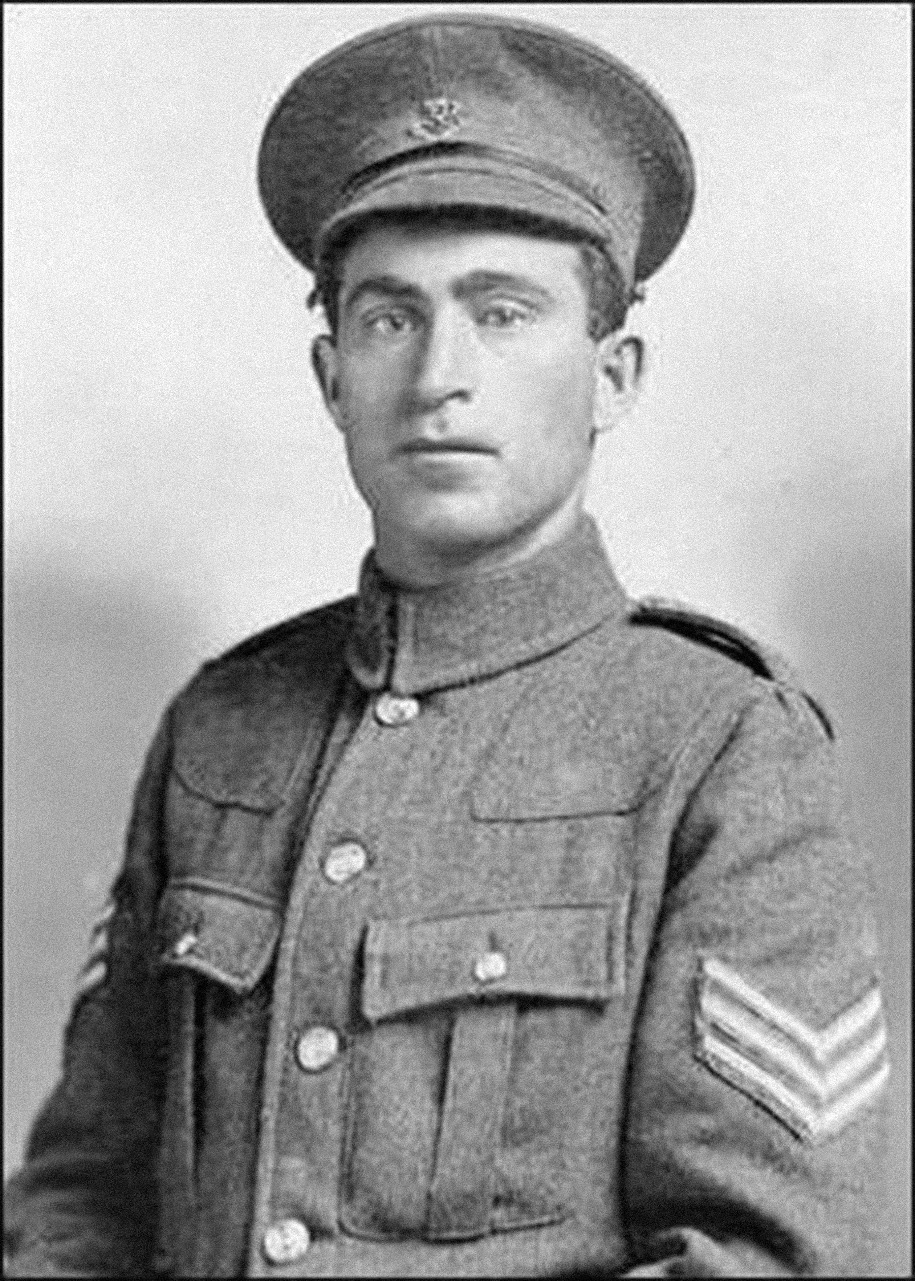 A head-and-shoulders, black and white photograph of a young man in uniform and cap.